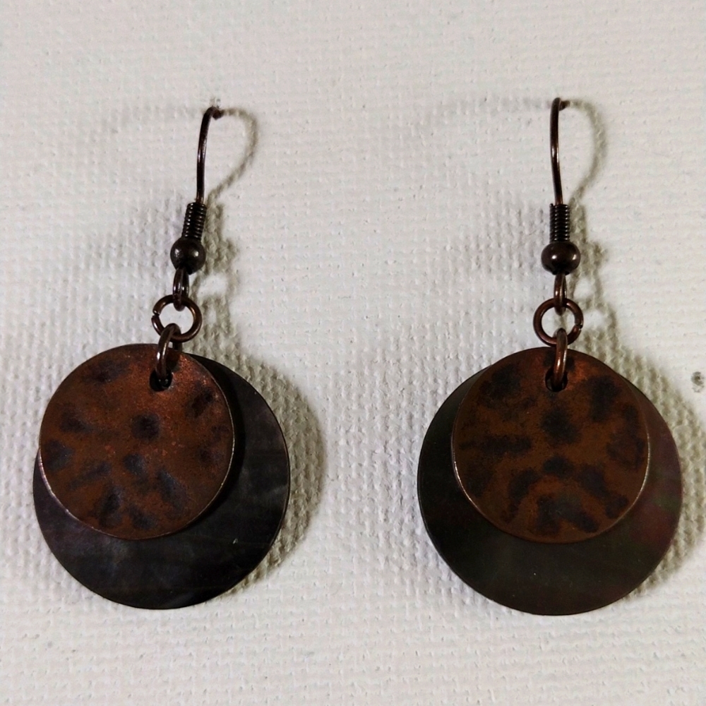 Lia Sofia dangling shell and copper colored medallion earrings.